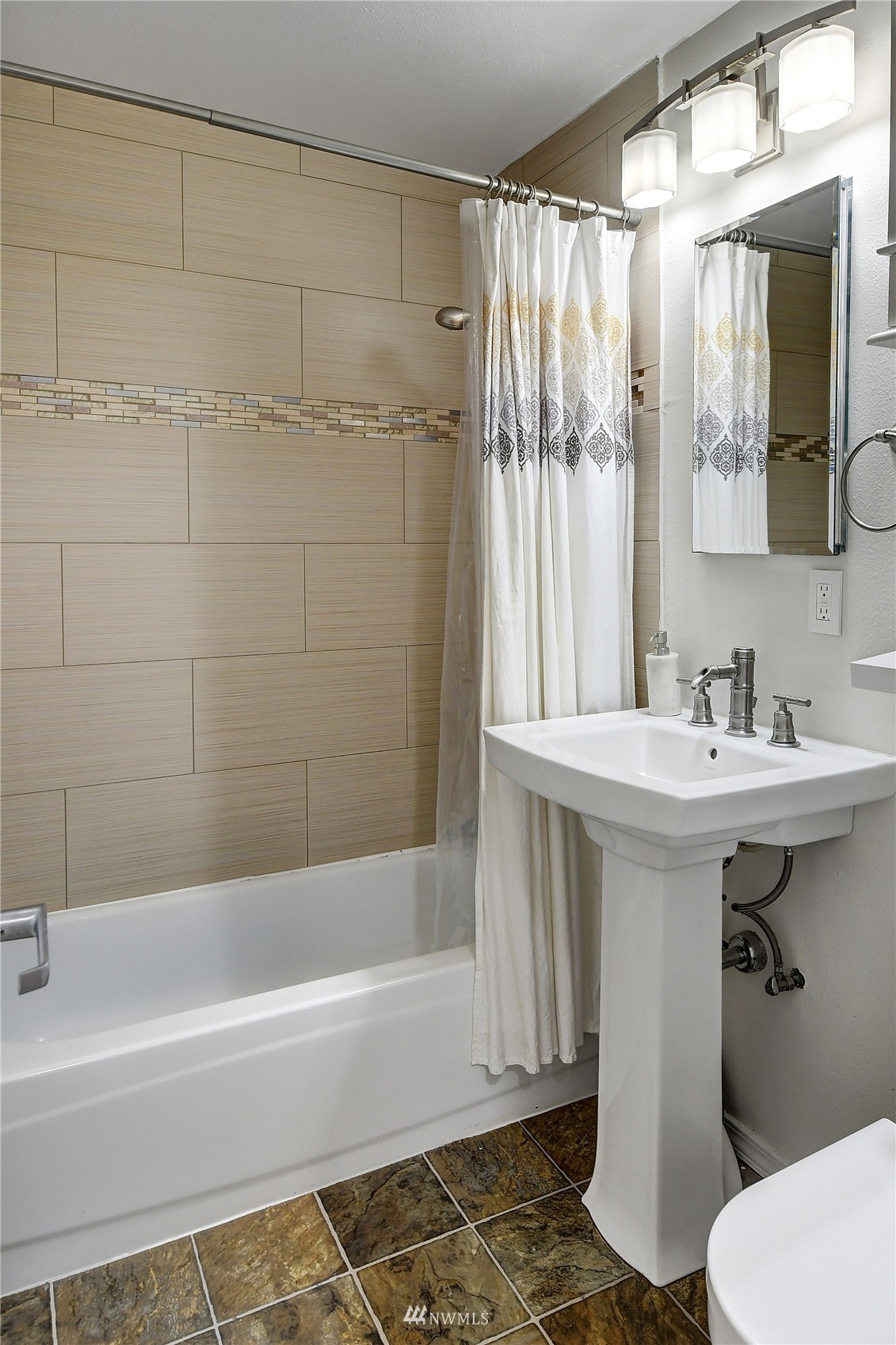 4515 Southeast 3rd Place Renton, WA 98059 - Photo 11 of 18 a bathroom with a sink mirror toilet and bathtub