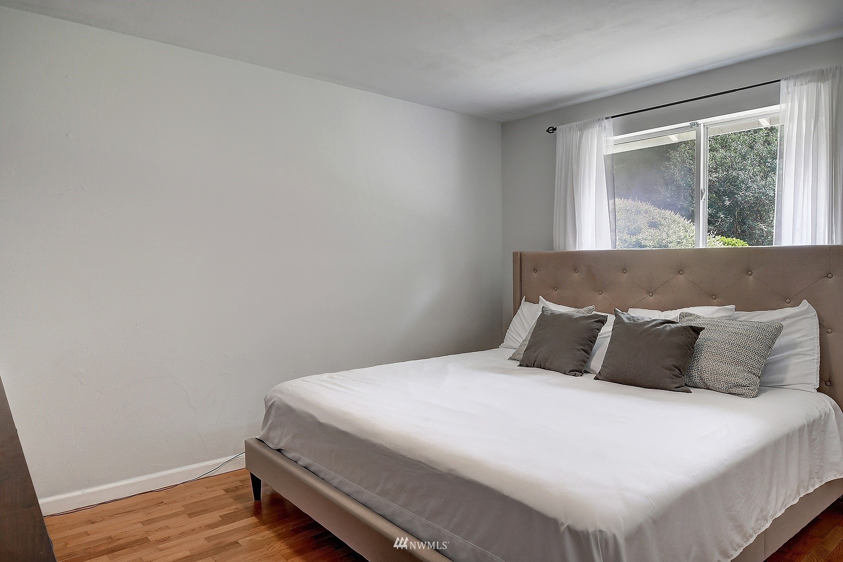 4515 Southeast 3rd Place Renton, WA 98059 - Photo 10 of 18 a bedroom with a bed and wooden floor