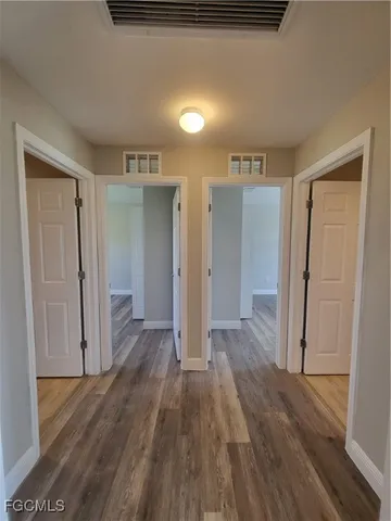a view of hallway with wooden floor