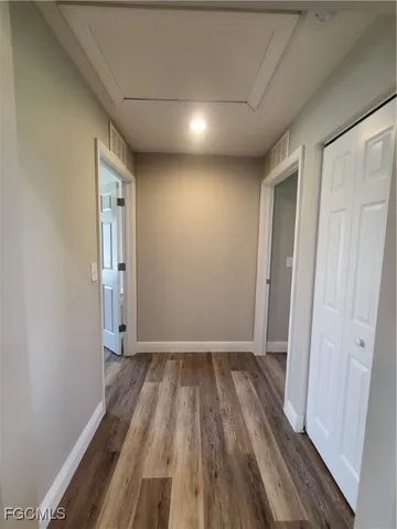 a view of hallway with wooden floor