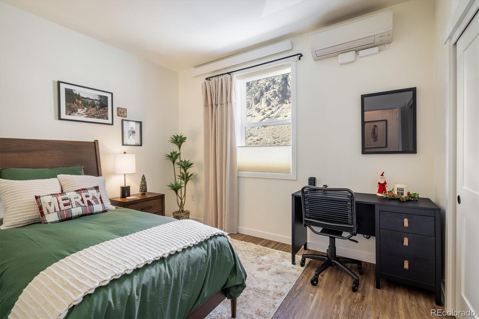 2121 Hummingbird Way, Unit 201 Georgetown, CO 80444 - Photo 12 of 29 a bedroom with a bed and a table in it