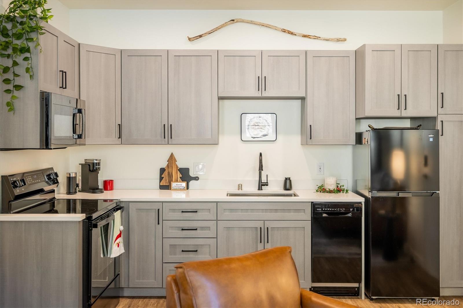 2121 Hummingbird Way, Unit 201 Georgetown, CO 80444 - Photo 6 of 29 a kitchen with stainless steel appliances a sink a stove a refrigerator and cabinets