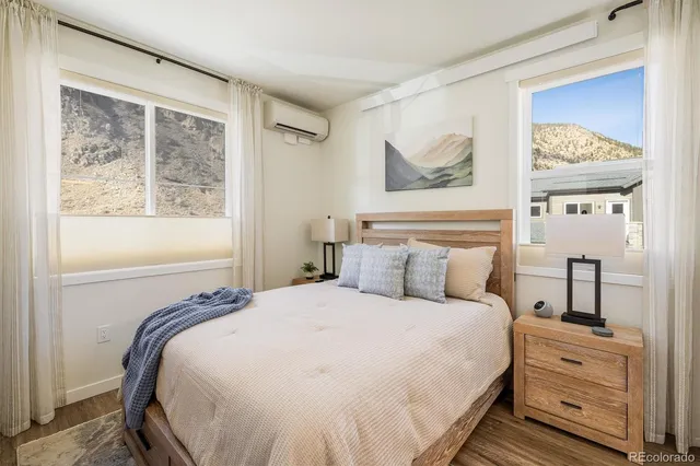 a bedroom with a bed and a painting on the wall