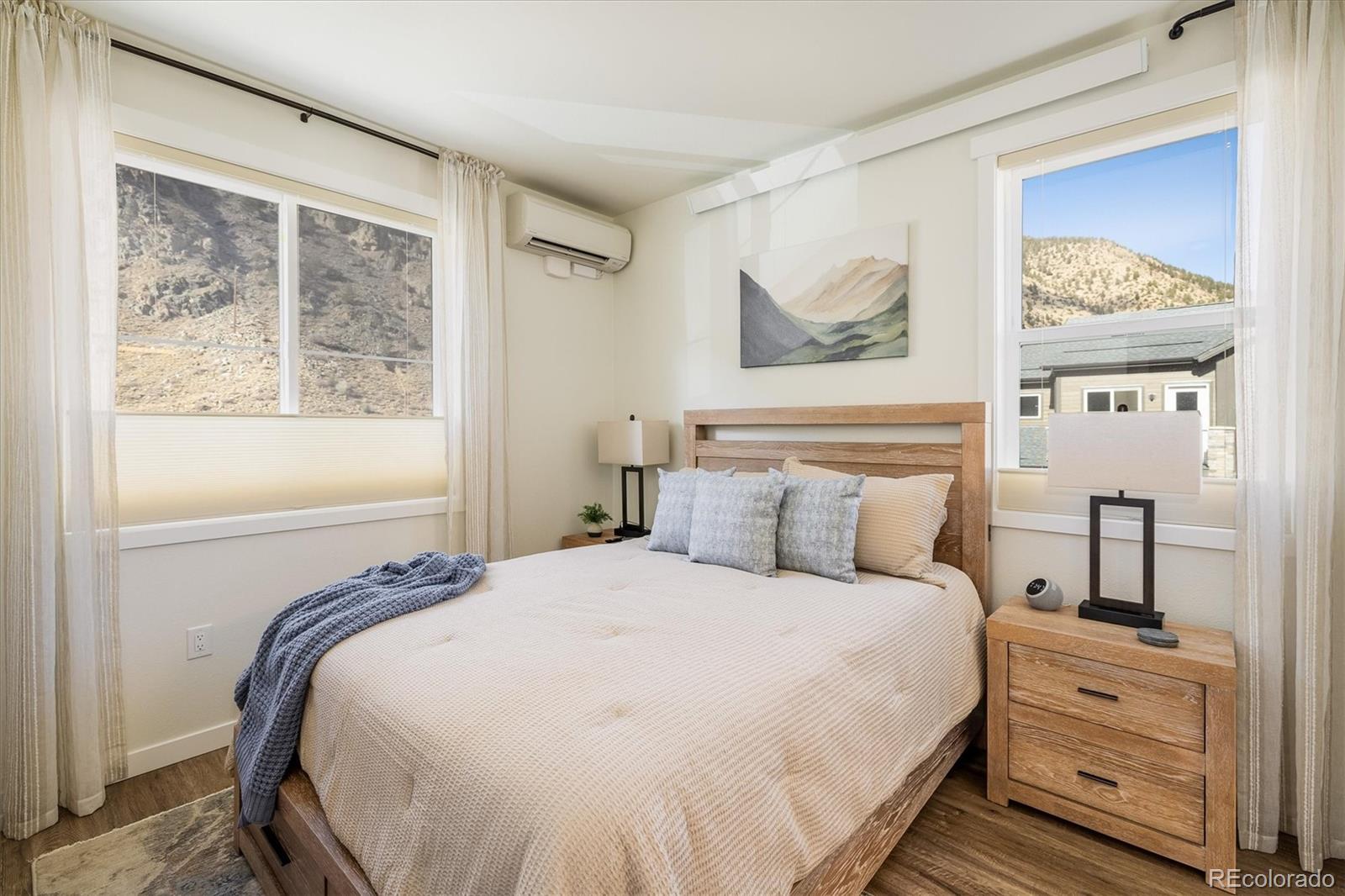 2121 Hummingbird Way, Unit 201 Georgetown, CO 80444 - Photo 8 of 29 a bedroom with a bed and a painting on the wall