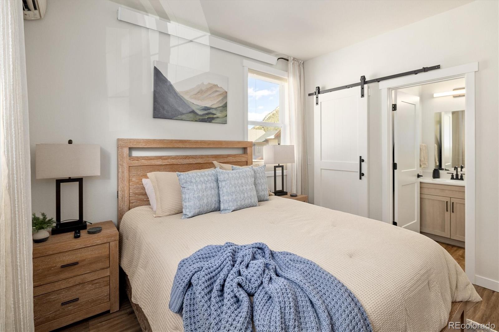 2121 Hummingbird Way, Unit 201 Georgetown, CO 80444 - Photo 10 of 29 a bedroom with a bed and a mirror