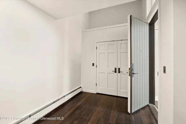 a view of an empty room with a fireplace and a window