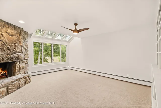 a view of an empty room with a fireplace