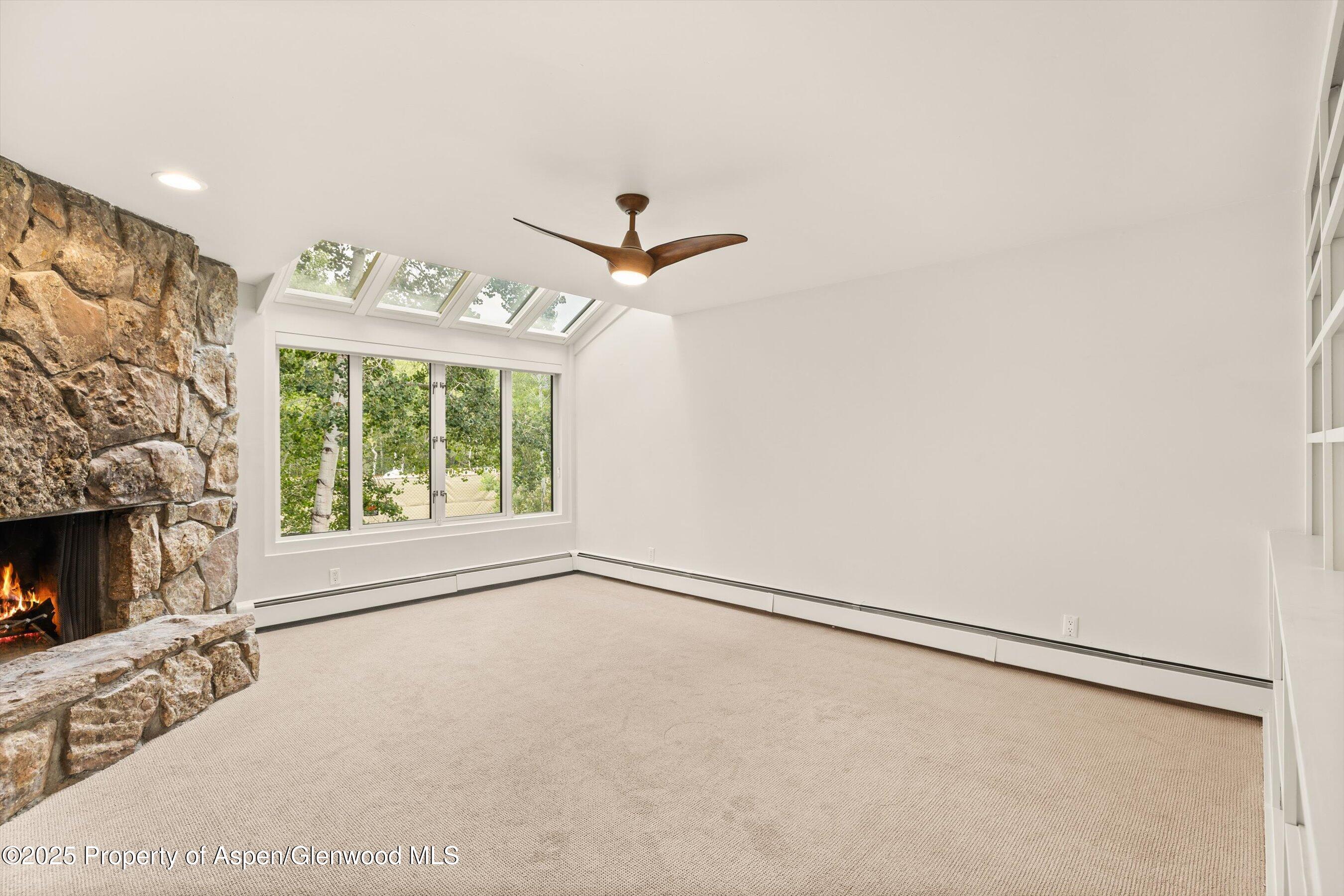 1443 Crystal Lake Road, Unit 3E Aspen, CO 81611 - Photo 12 of 34 a view of an empty room with a fireplace and a window