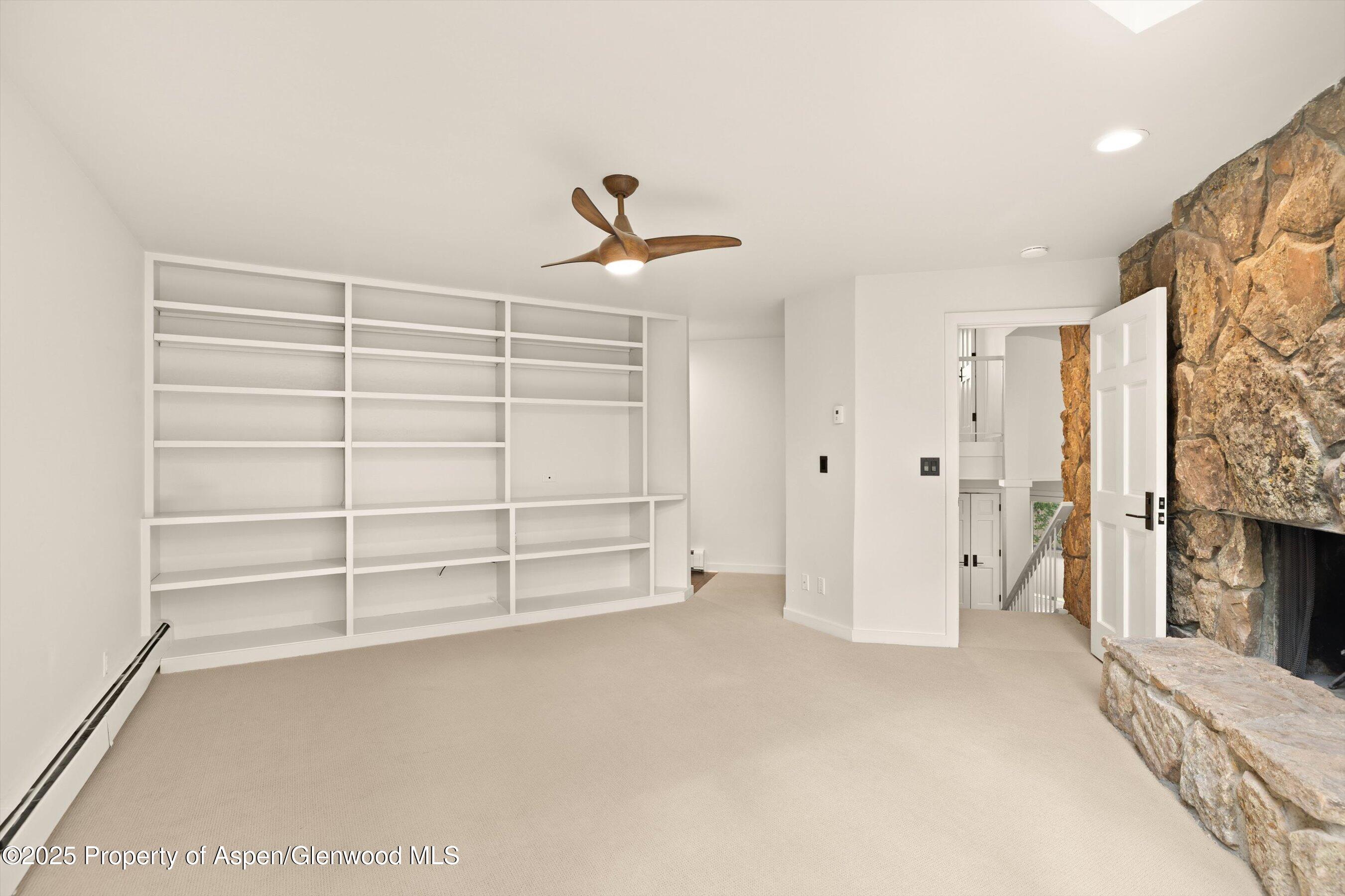 1443 Crystal Lake Road, Unit 3E Aspen, CO 81611 - Photo 13 of 34 a view of an empty room with a fireplace