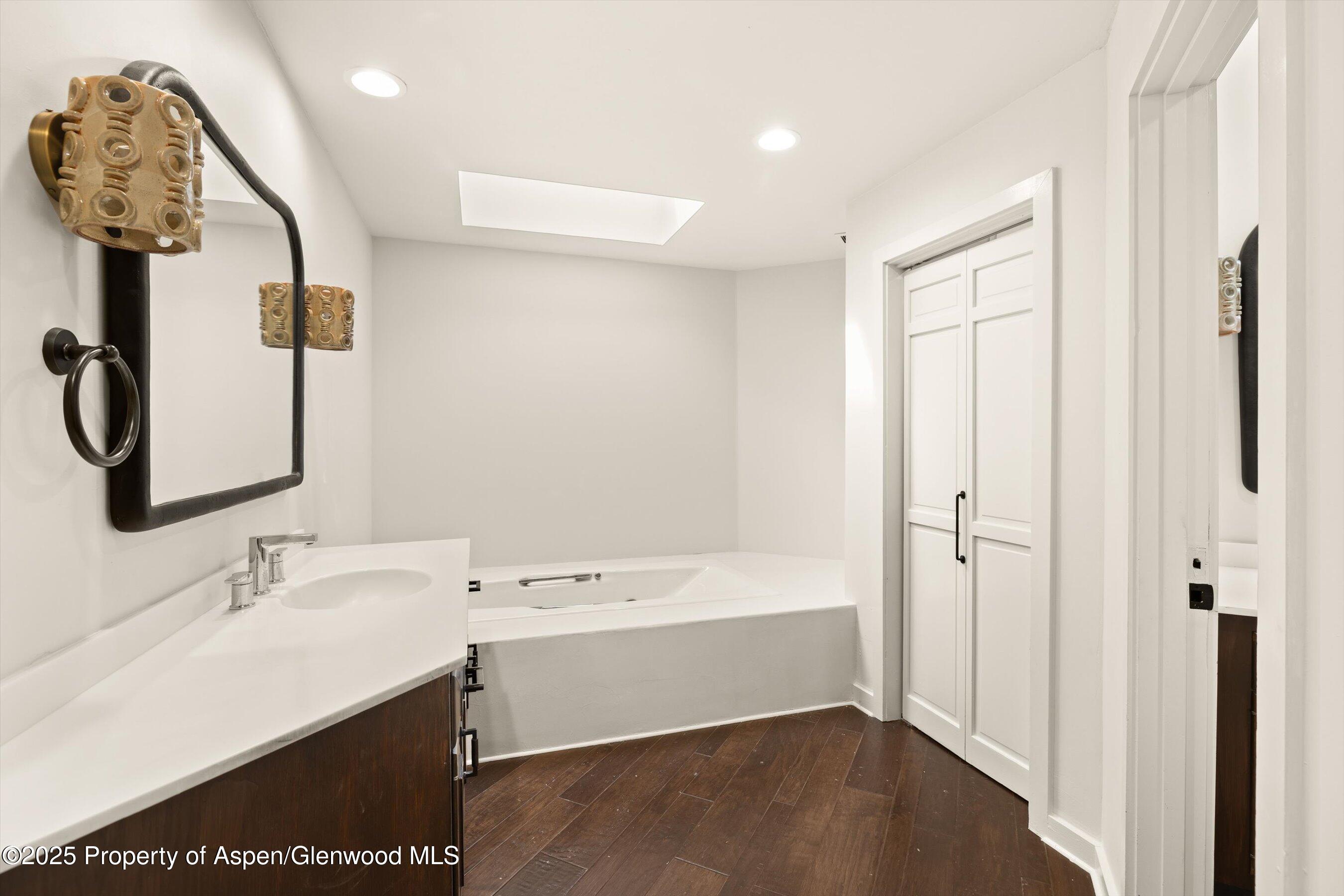 1443 Crystal Lake Road, Unit 3E Aspen, CO 81611 - Photo 15 of 34 a bathroom with a sink a mirror and shower