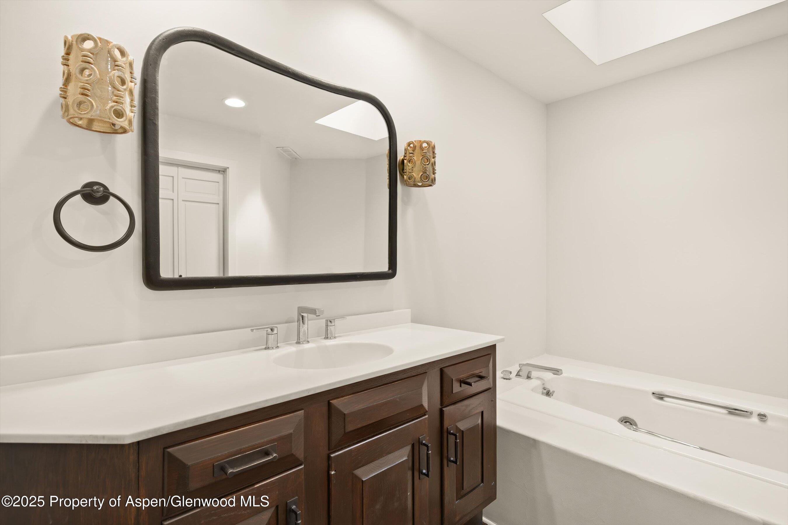 1443 Crystal Lake Road, Unit 3E Aspen, CO 81611 - Photo 16 of 34 a bathroom with a sink vanity and a mirror
