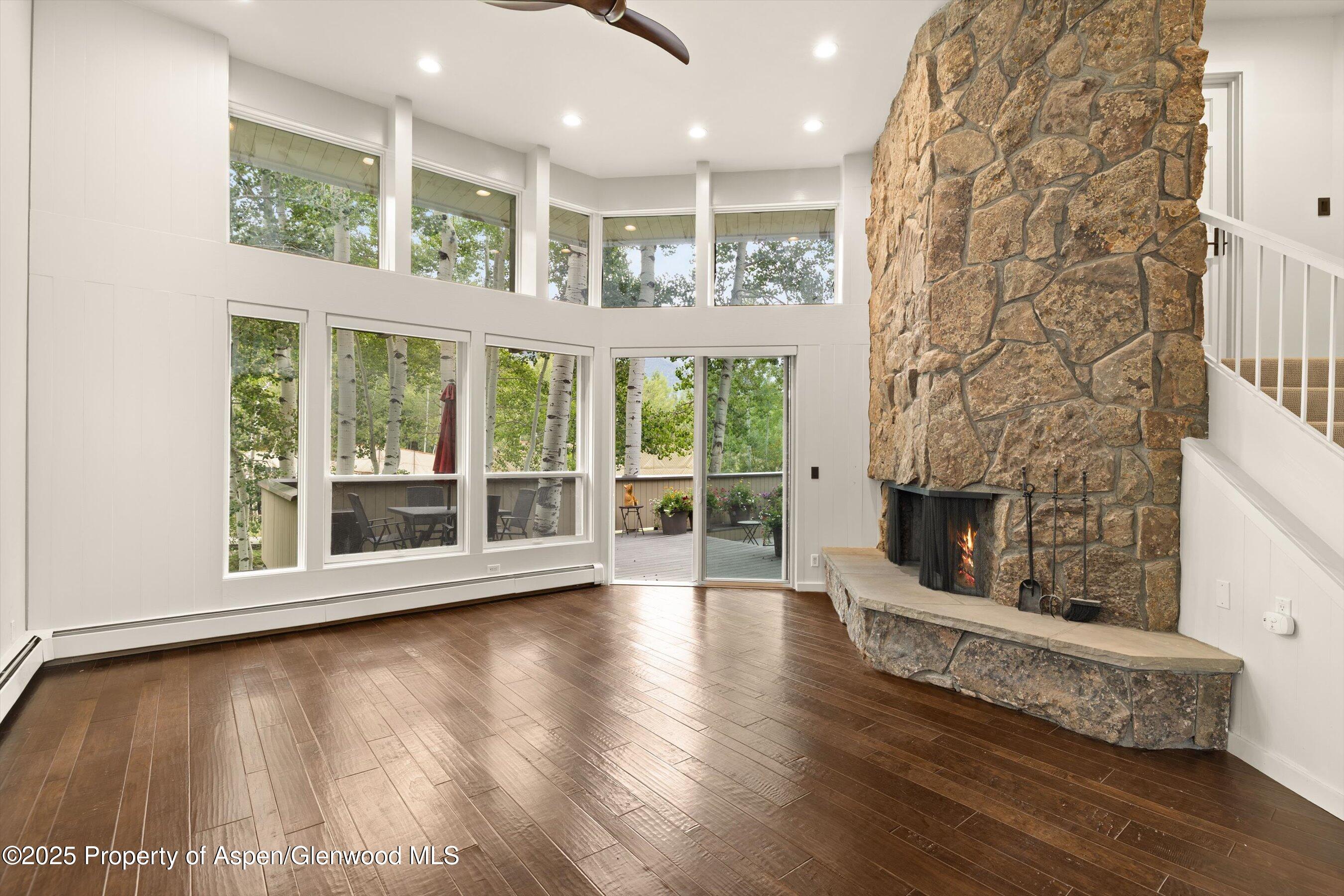 1443 Crystal Lake Road, Unit 3E Aspen, CO 81611 - Photo 2 of 34 a view of an empty room with wooden floor and a window
