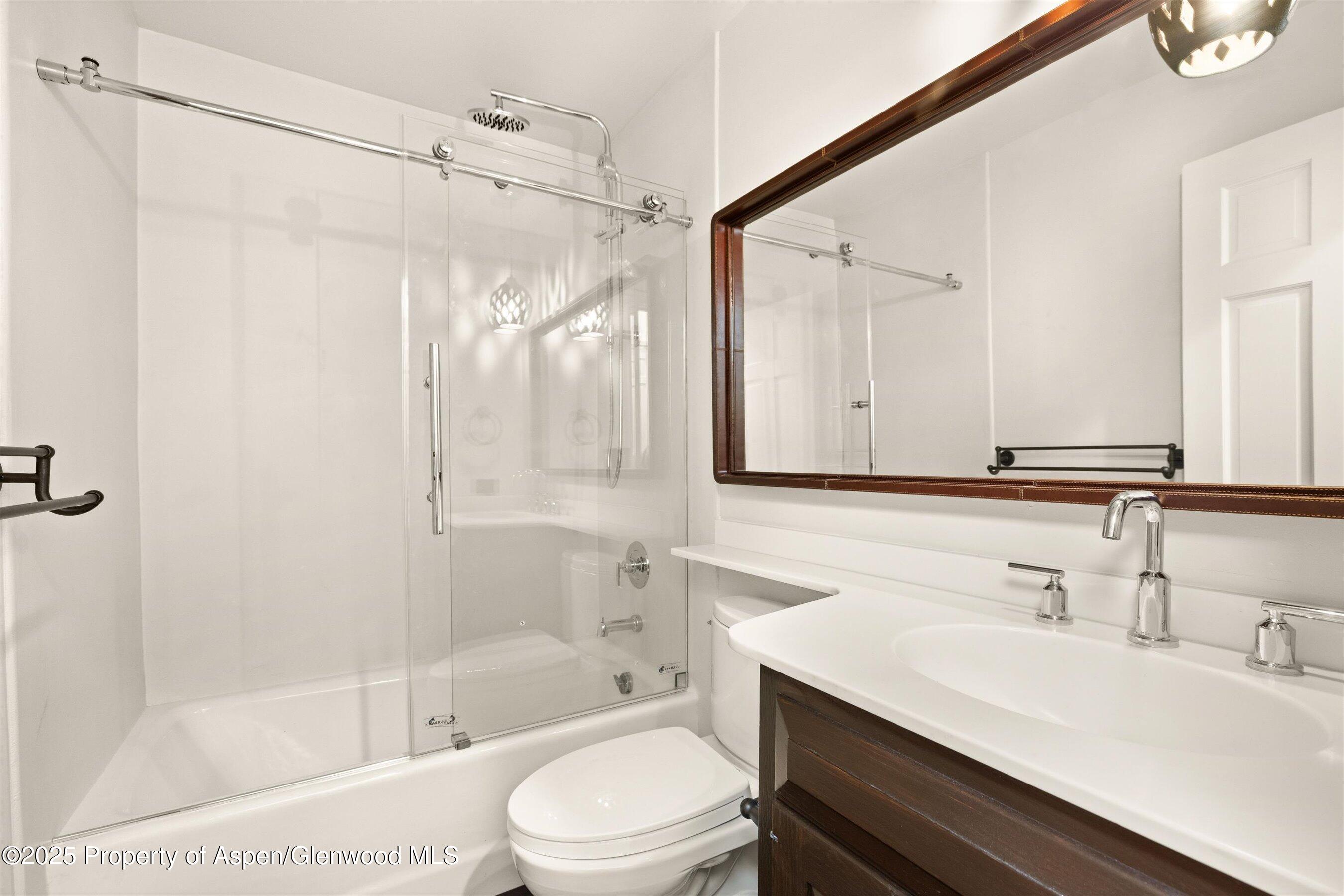 1443 Crystal Lake Road, Unit 3E Aspen, CO 81611 - Photo 22 of 34 a bathroom with a bathtub shower sink vanity and toilet