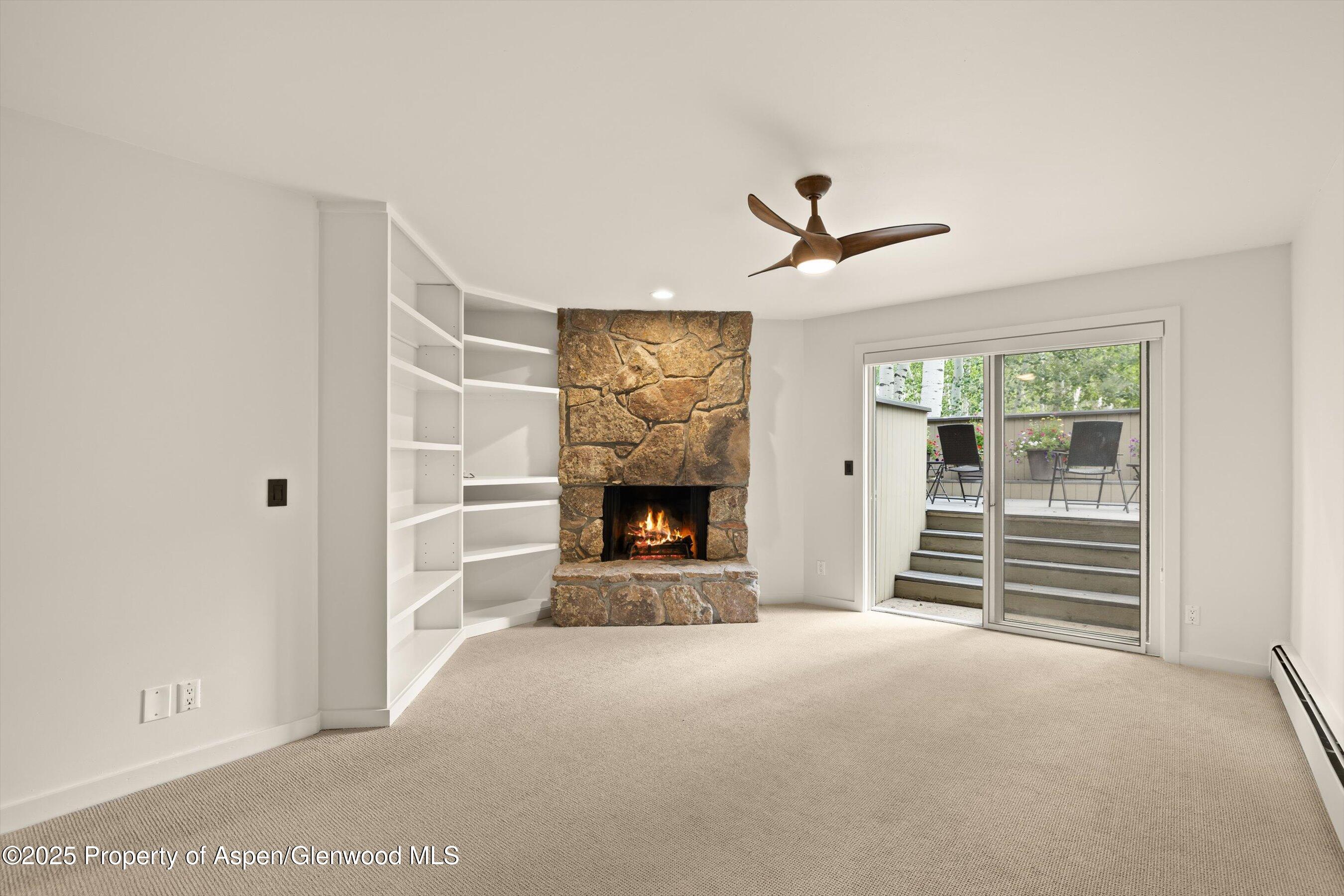 1443 Crystal Lake Road, Unit 3E Aspen, CO 81611 - Photo 24 of 34 a view of a livingroom with a fireplace and a ceiling fan
