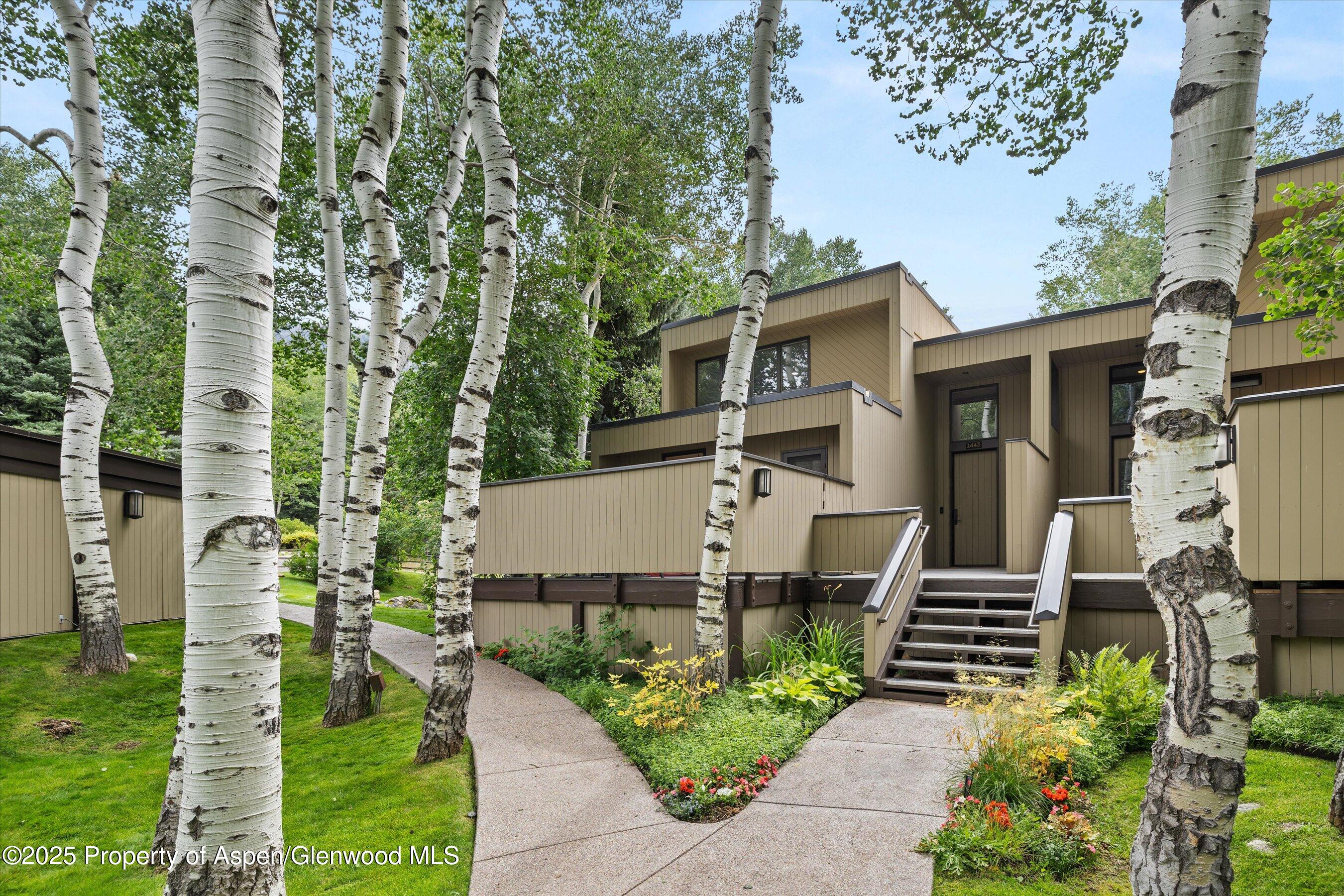 1443 Crystal Lake Road, Unit 3E Aspen, CO 81611 - Photo 32 of 34 a front view of a house with garden
