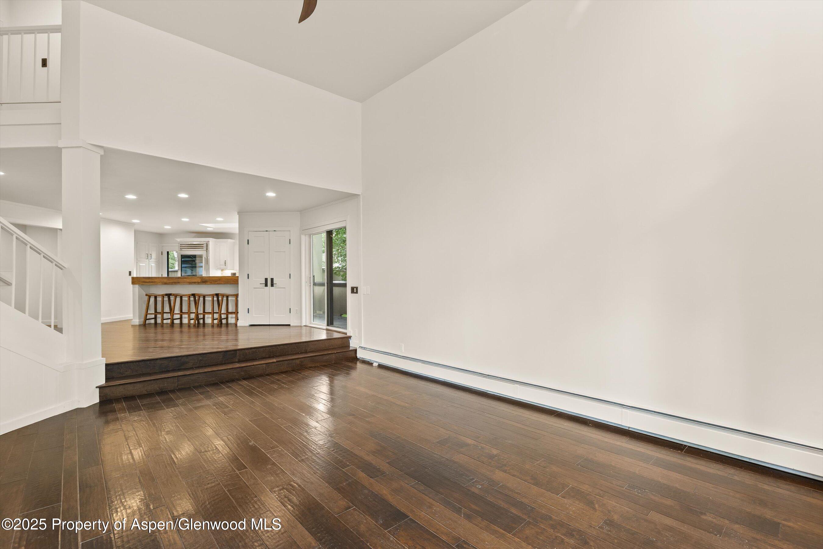 1443 Crystal Lake Road, Unit 3E Aspen, CO 81611 - Photo 4 of 34 an empty room with wooden floor and windows