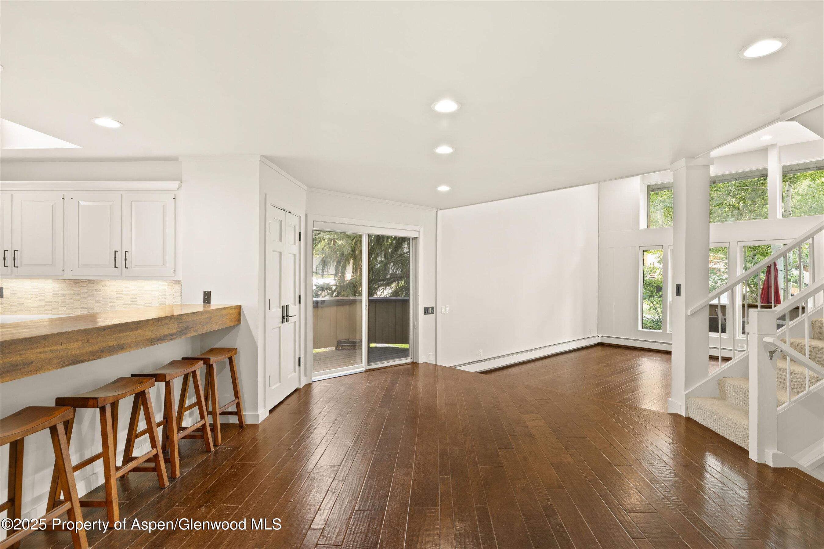 1443 Crystal Lake Road, Unit 3E Aspen, CO 81611 - Photo 6 of 34 a view of an empty room with wooden floor and a window