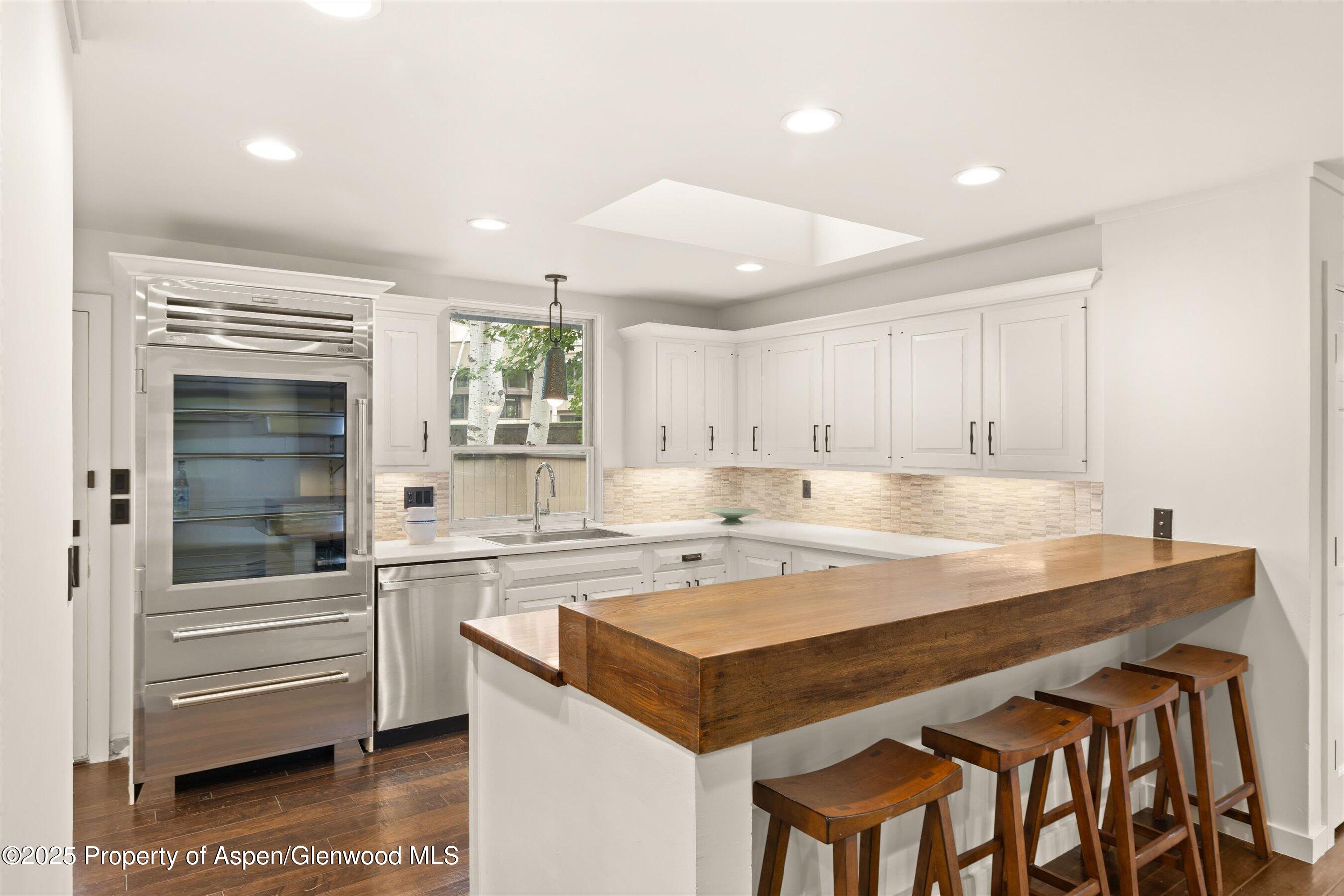 1443 Crystal Lake Road, Unit 3E Aspen, CO 81611 - Photo 7 of 34 a kitchen with a stove a refrigerator and a sink