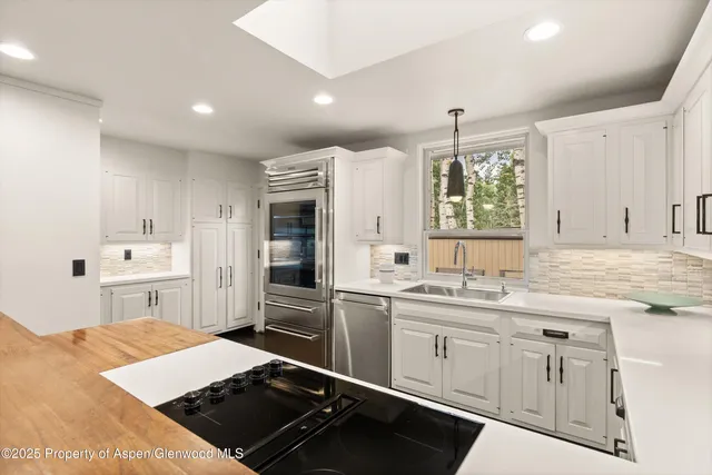 a kitchen with a sink stove and cabinets