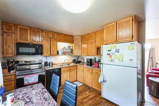 a kitchen with a sink appliances and cabinets
