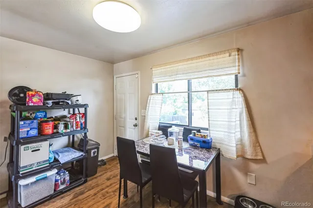 a view of a dining room with furniture and a window