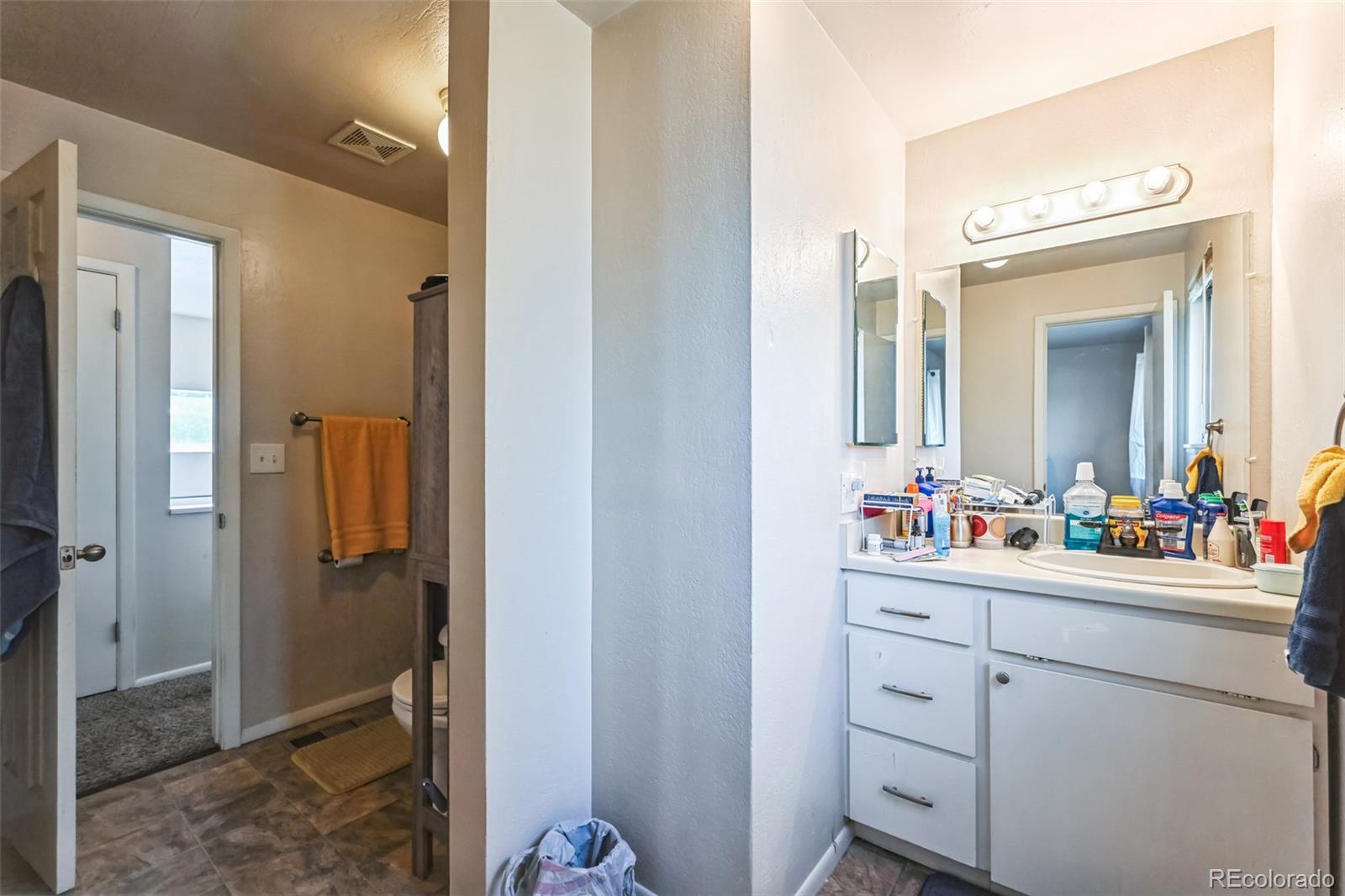 15640 East Eldorado Drive Aurora, CO 80013 - Photo 20 of 33 a bathroom with a double vanity sink mirror and shower