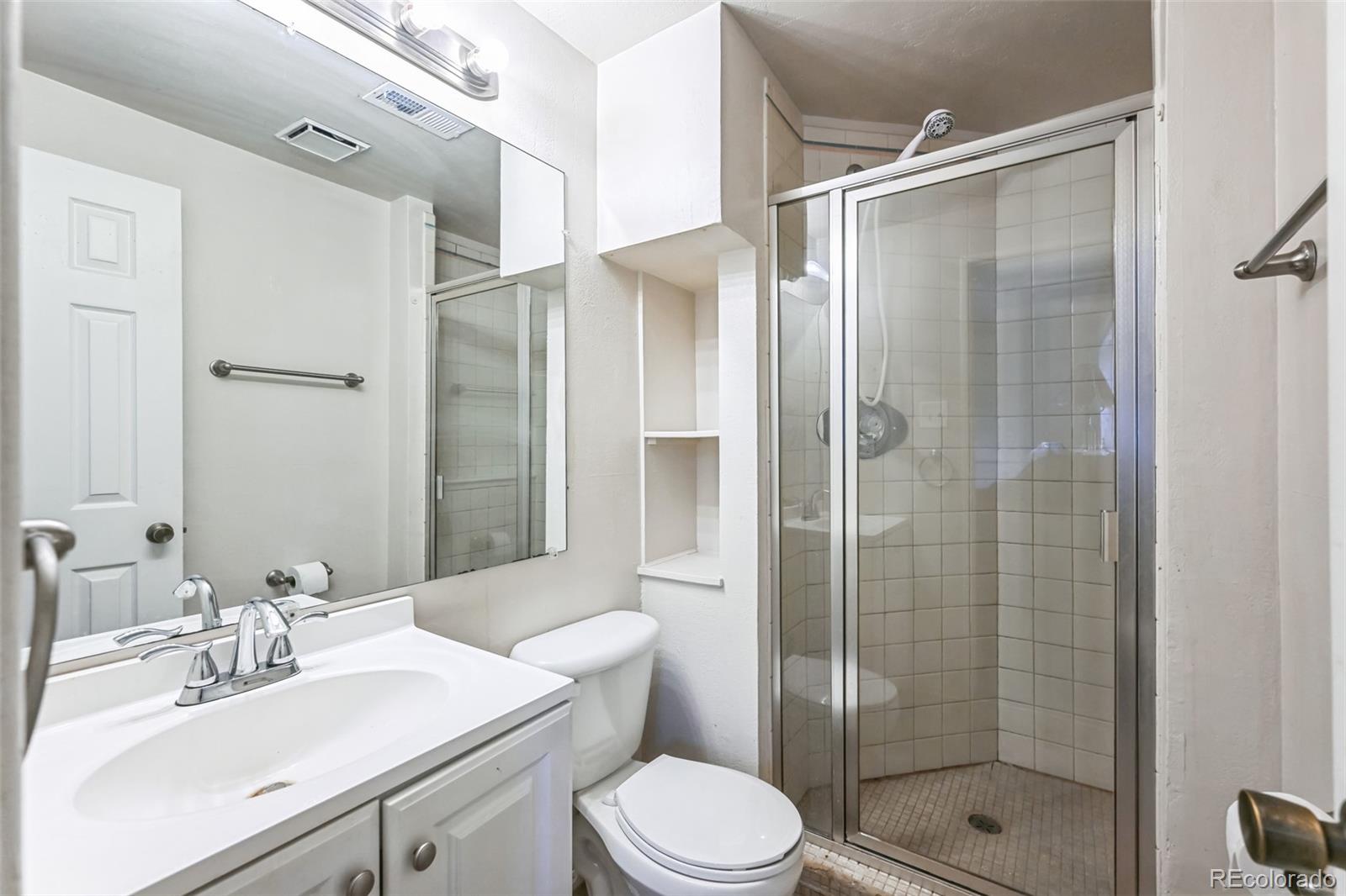 15640 East Eldorado Drive Aurora, CO 80013 - Photo 22 of 33 a bathroom with a sink toilet and shower