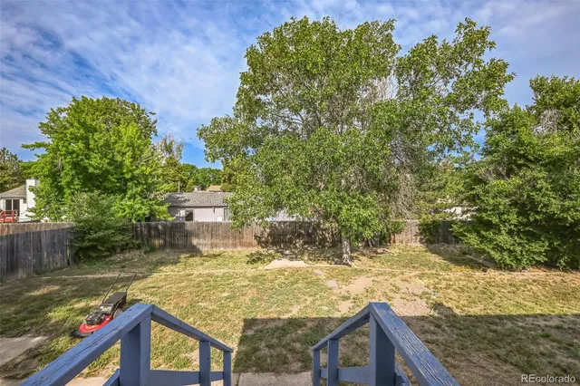 a view of a house with pool and sitting area