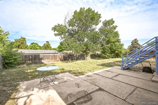 a view of yard with green space and seating area