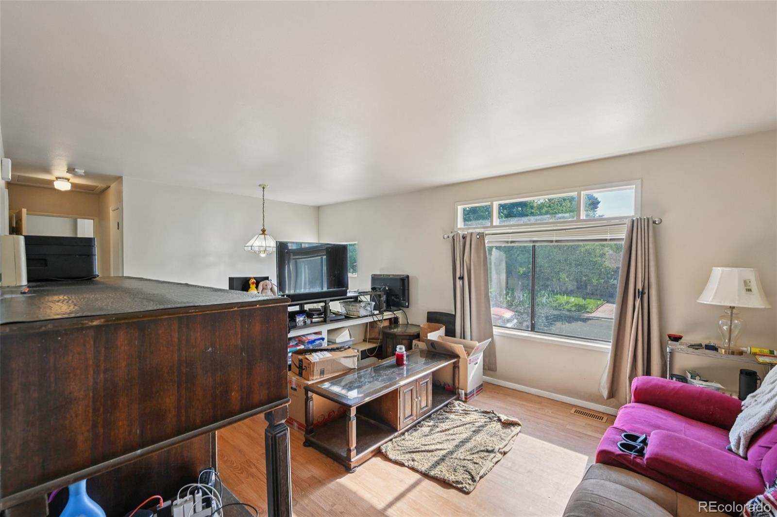 15640 East Eldorado Drive Aurora, CO 80013 - Photo 6 of 33 a living room with furniture and a flat screen tv