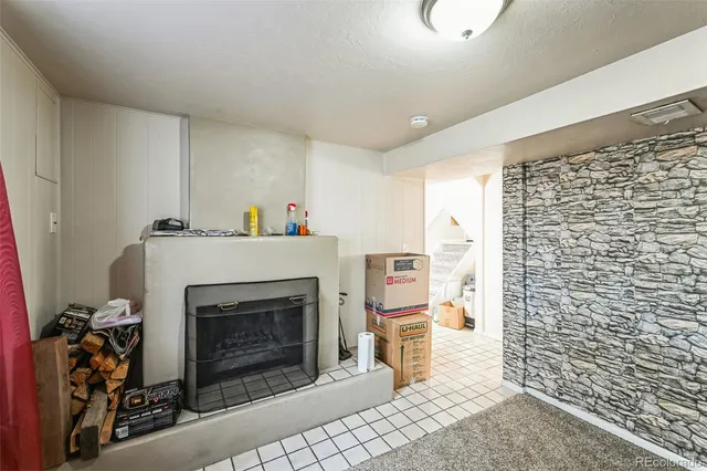 a living room with a fireplace and a walk in closet