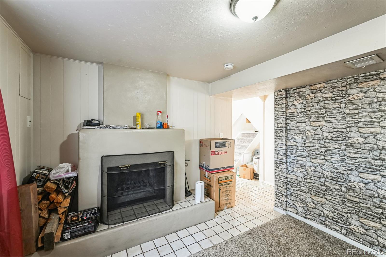 15640 East Eldorado Drive Aurora, CO 80013 - Photo 8 of 33 a living room with a fireplace and a walk in closet