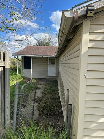 a yellow house with trees in front of it