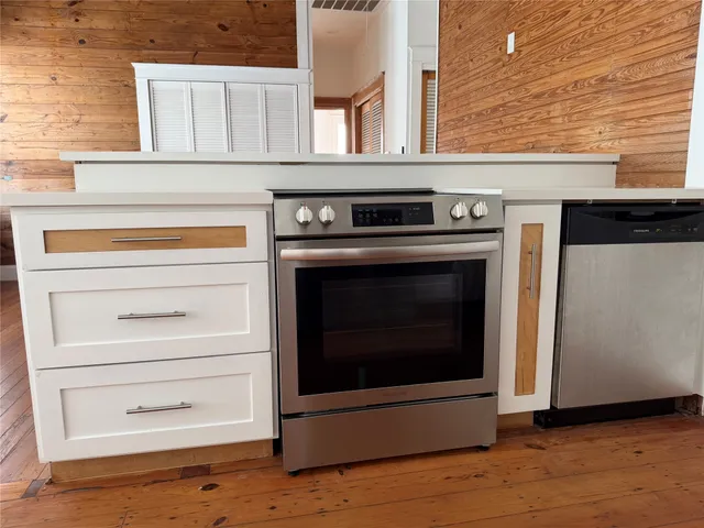 a stove top oven sitting inside of a kitchen