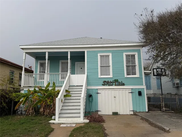 a view of a house with a small yard and plants
