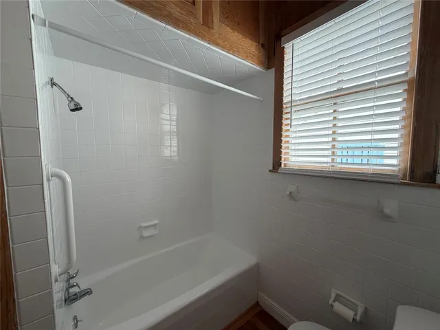 a bathroom with a bathtub and a shower