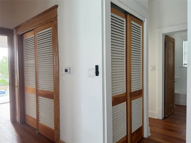 a view of a hallway with wooden floor and stairs