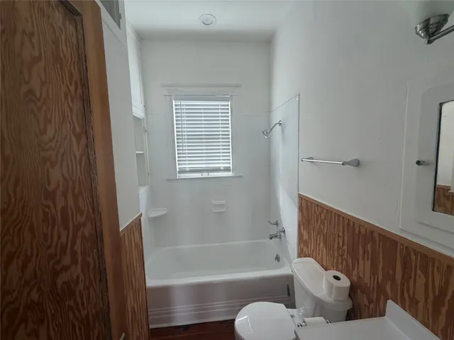 a bathroom with a tub toilet and sink
