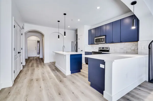 a kitchen with wooden cabinets and stainless steel appliances