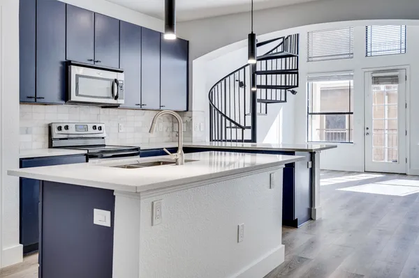 a kitchen with stainless steel appliances a sink and a microwave