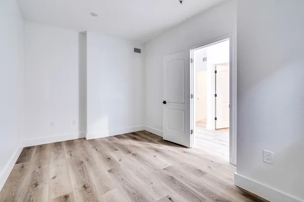 a view of an empty room and wooden floor
