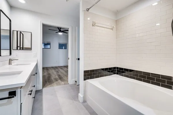 a spacious bathroom with a bathtub and a sink