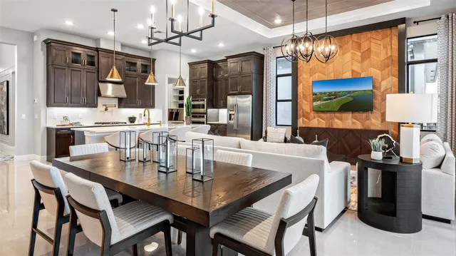 a dining table with a large window and chairs