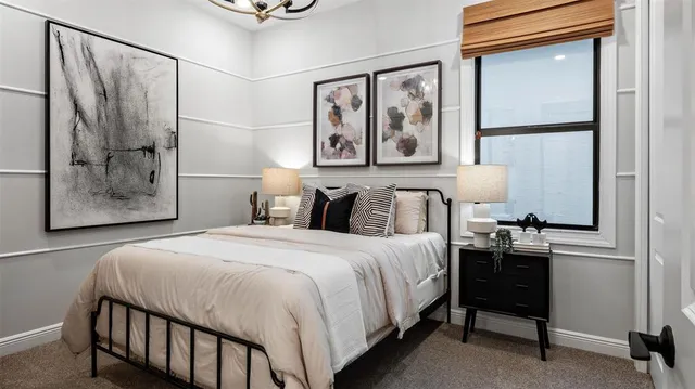 a bedroom with a bed and a table in it