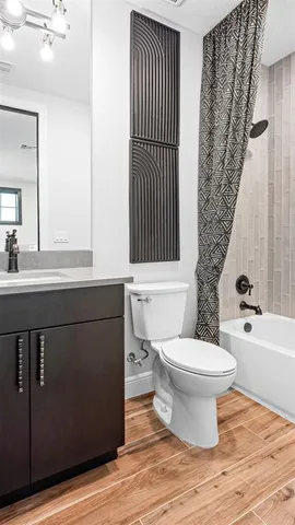 a bathroom with a sink toilet and shower