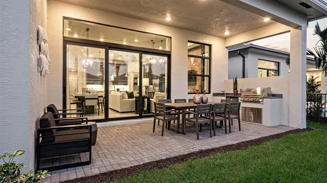 a living room with furniture a large window and a dining table