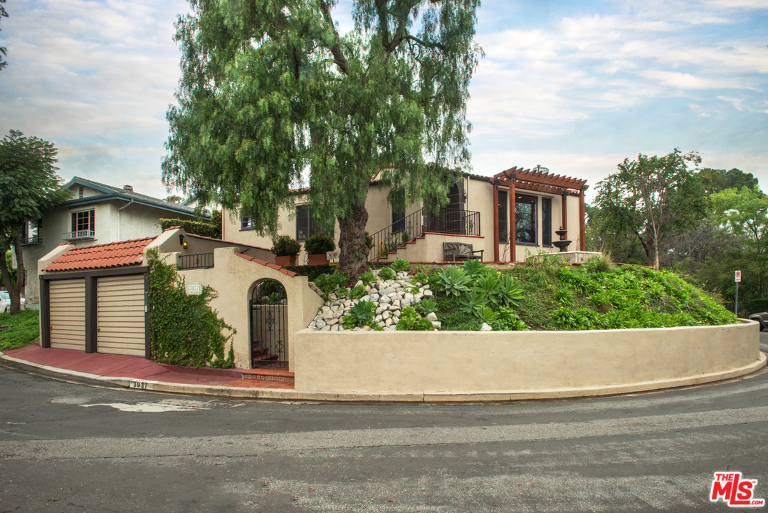 a view of a white house with a street