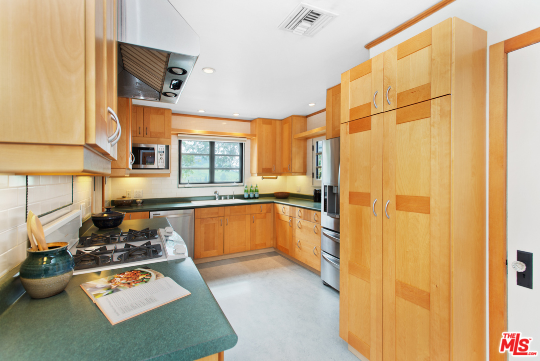 3937 Roderick Road Los Angeles, CA 90065 - Photo 11 of 28 a kitchen with a refrigerator and a stove