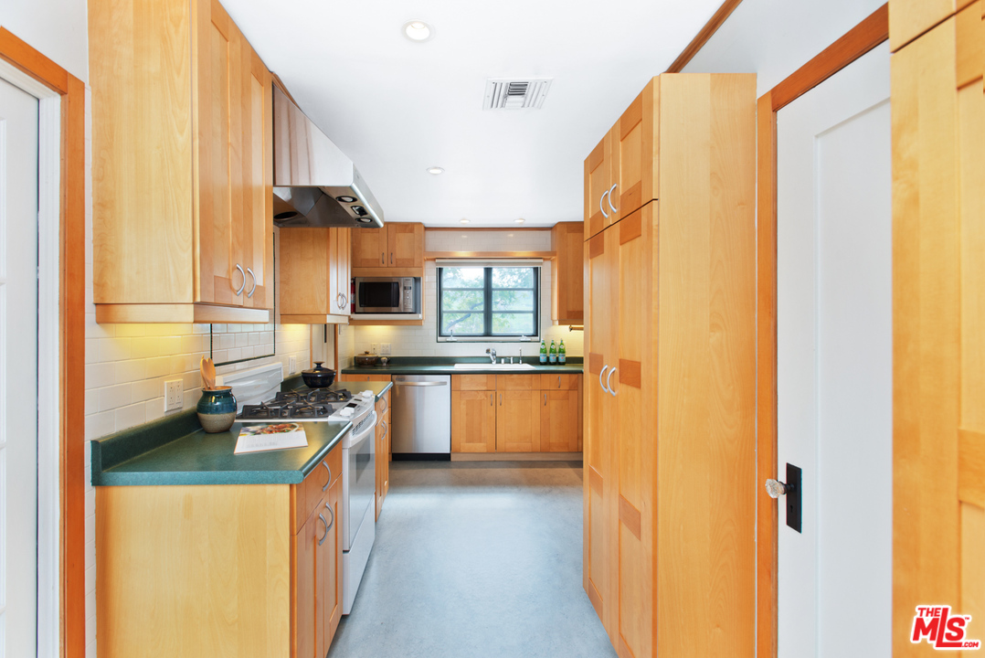 3937 Roderick Road Los Angeles, CA 90065 - Photo 12 of 28 a kitchen with stainless steel appliances a sink stove and a refrigerator
