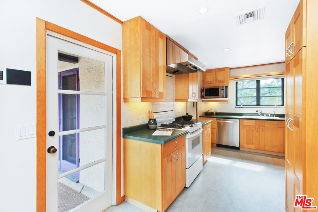 3937 Roderick Road Los Angeles, CA 90065 - Photo 13 of 28 a kitchen with stainless steel appliances granite countertop a stove and a sink